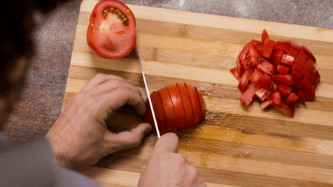 cooking food making dinner lunch breakfast slicing tomatoes tomato cutting board